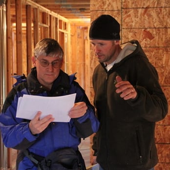 Engineer reviewing framing with contractor